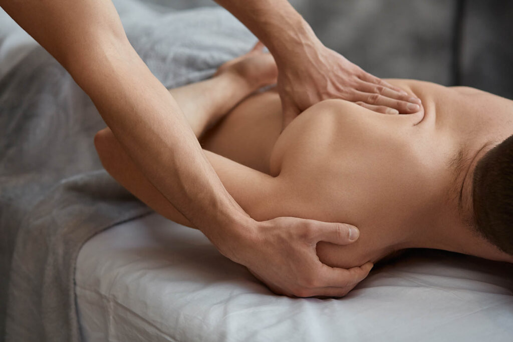 Young handsome man enjoying a back massage. Professional massage